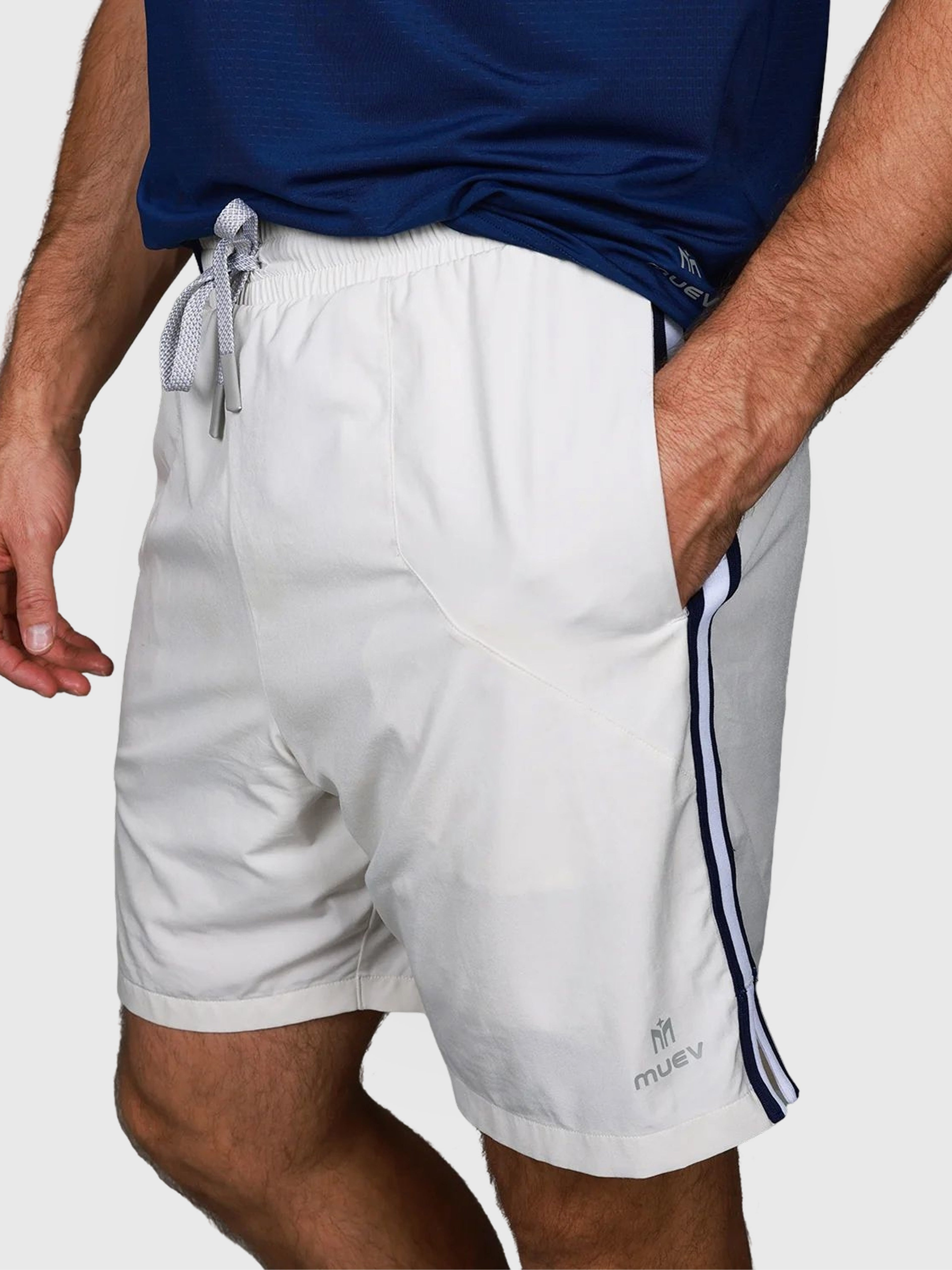 Man wearing white Court Short by MUEV with navy side stripes designed for padel and pickleball clothing