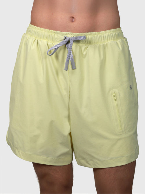 Front view of citron Apex Pro Compression Short by MUEV with elastic waistband and zippered side pocket for padel clothing
