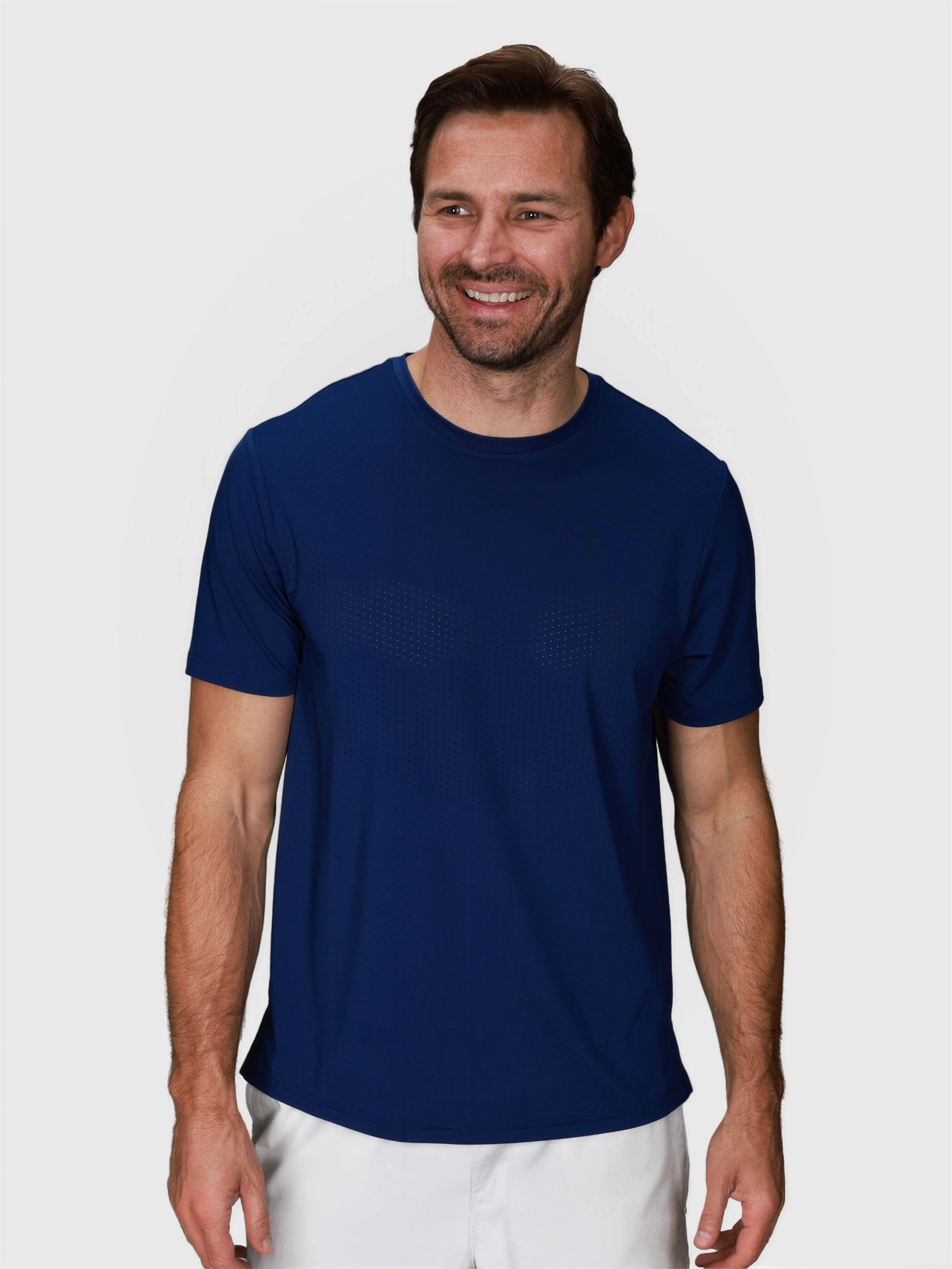man wearing navy Chevron Tee by MUEV designed for padel and pickleball clothing smiling front view