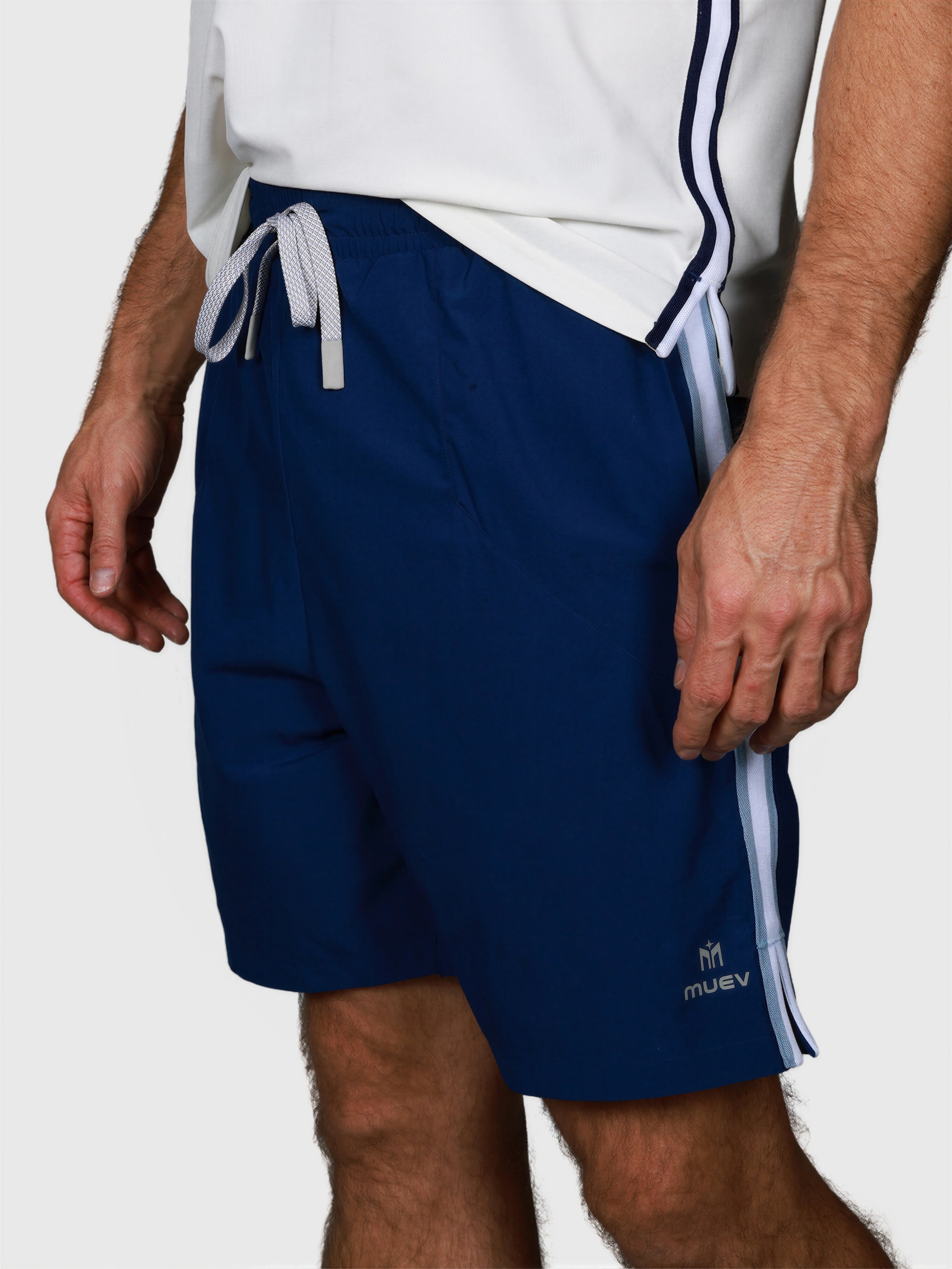 Man wearing Navy Court Short by MUEV designed for padel and pickleball sportswear with side stripe detail