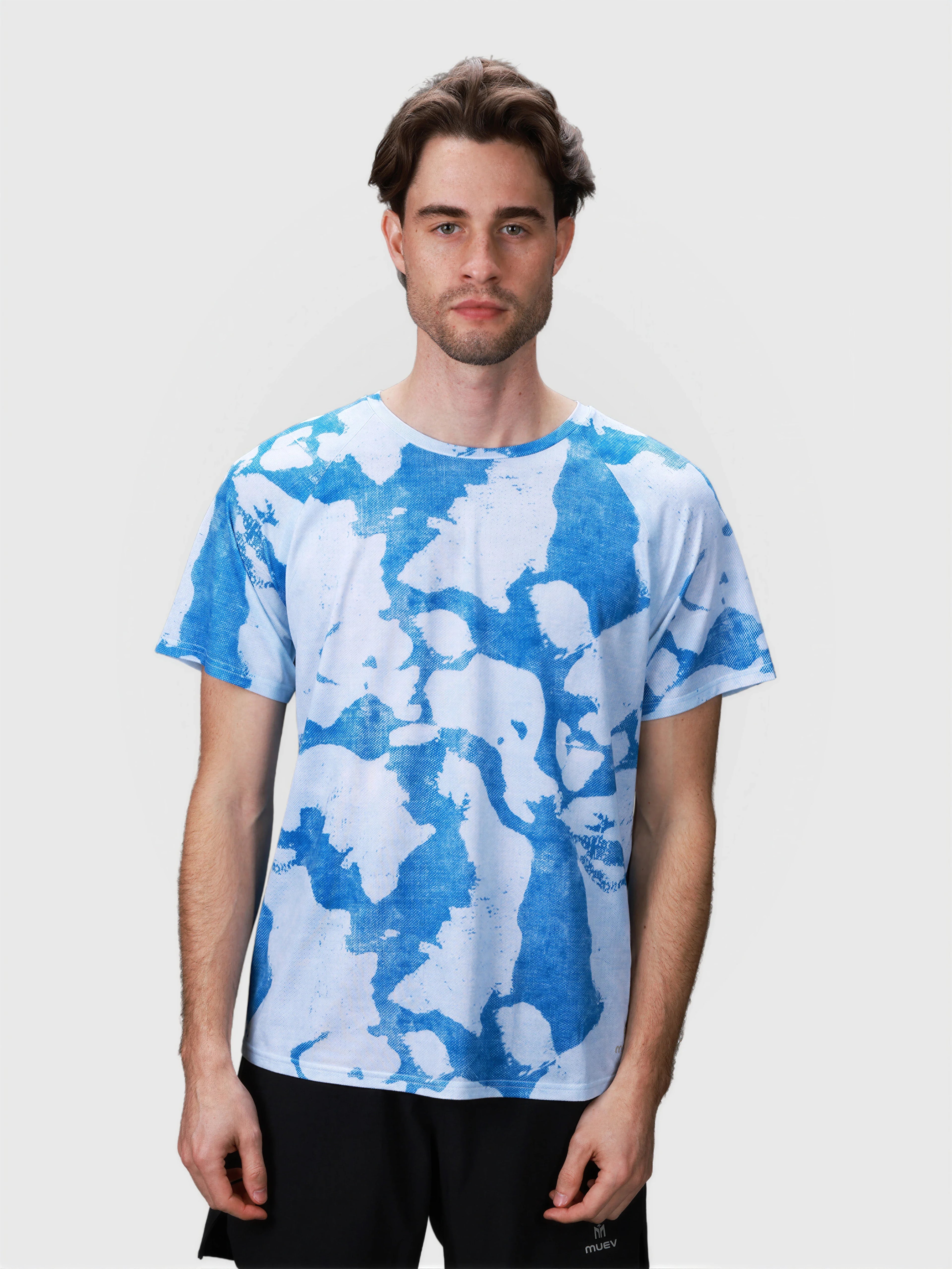 Front view of man wearing blue and white Digital Camo Dink Performance Tee in pickleball apparel by MUEV