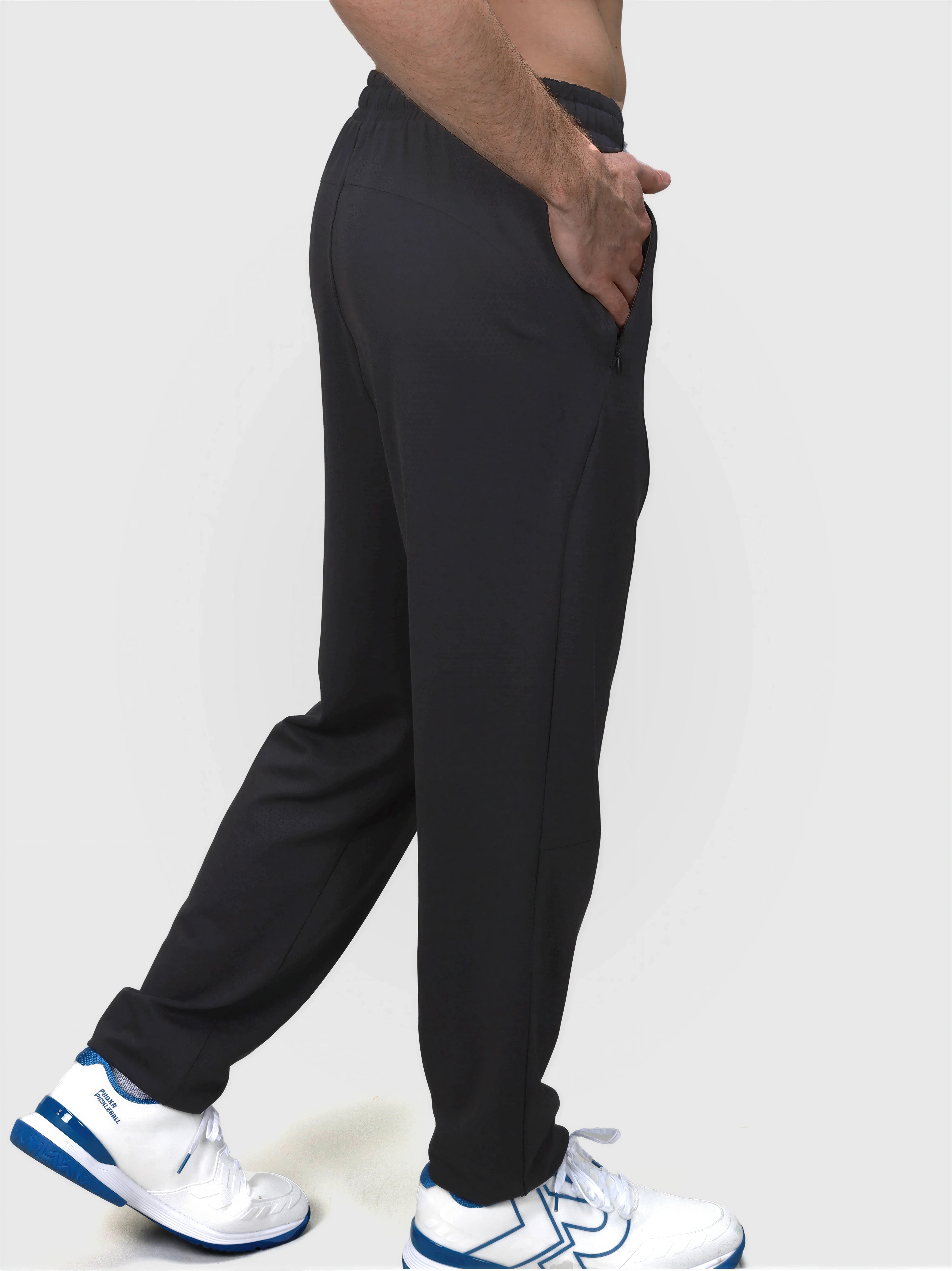 Side view of man wearing black Echelon Jogger by MUEV in lightweight padel and pickleball apparel