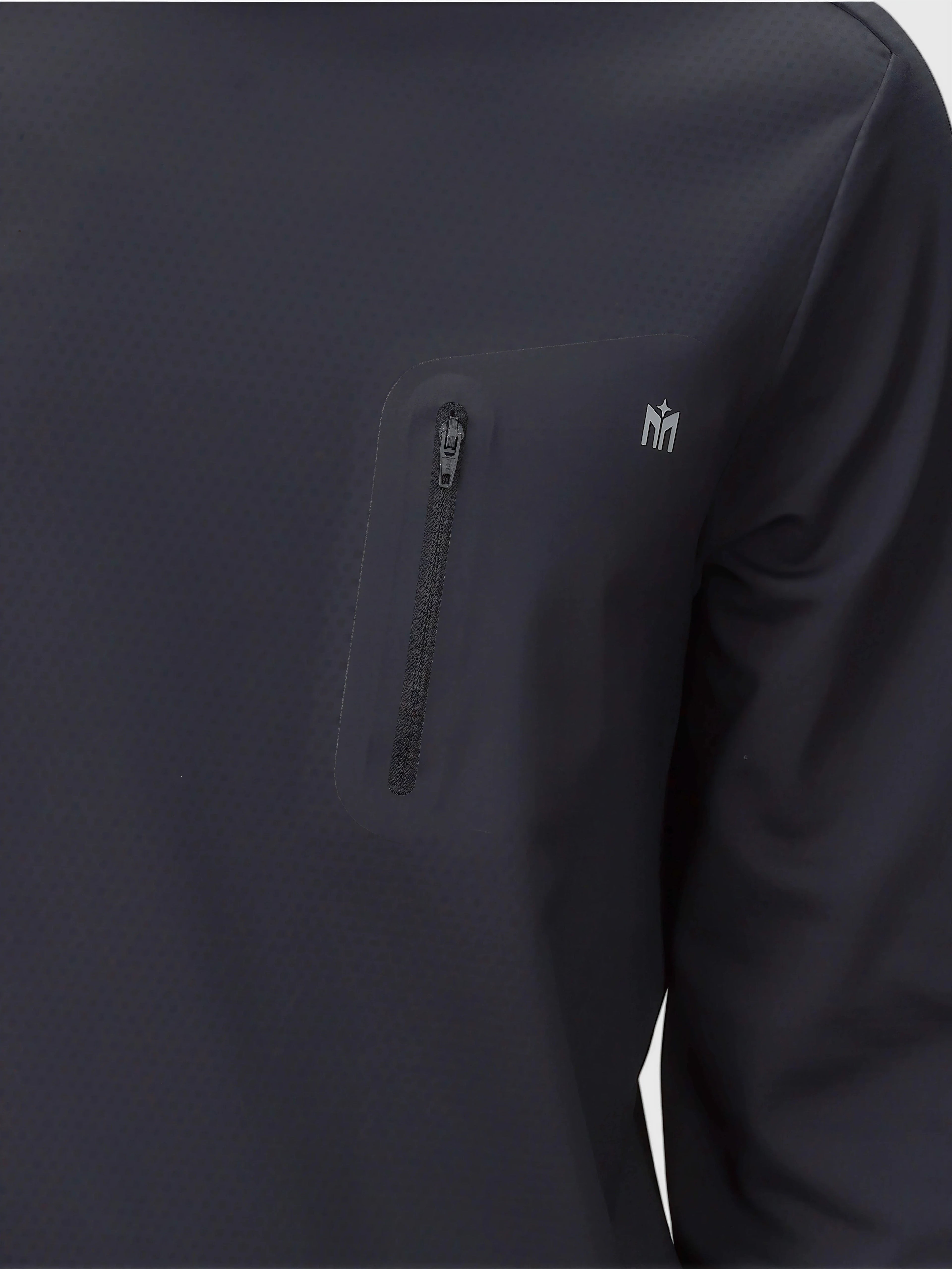 Close-up of black Echelon Long Sleeve Shirt by MUEV with zippered chest pocket for padel and pickleball apparel