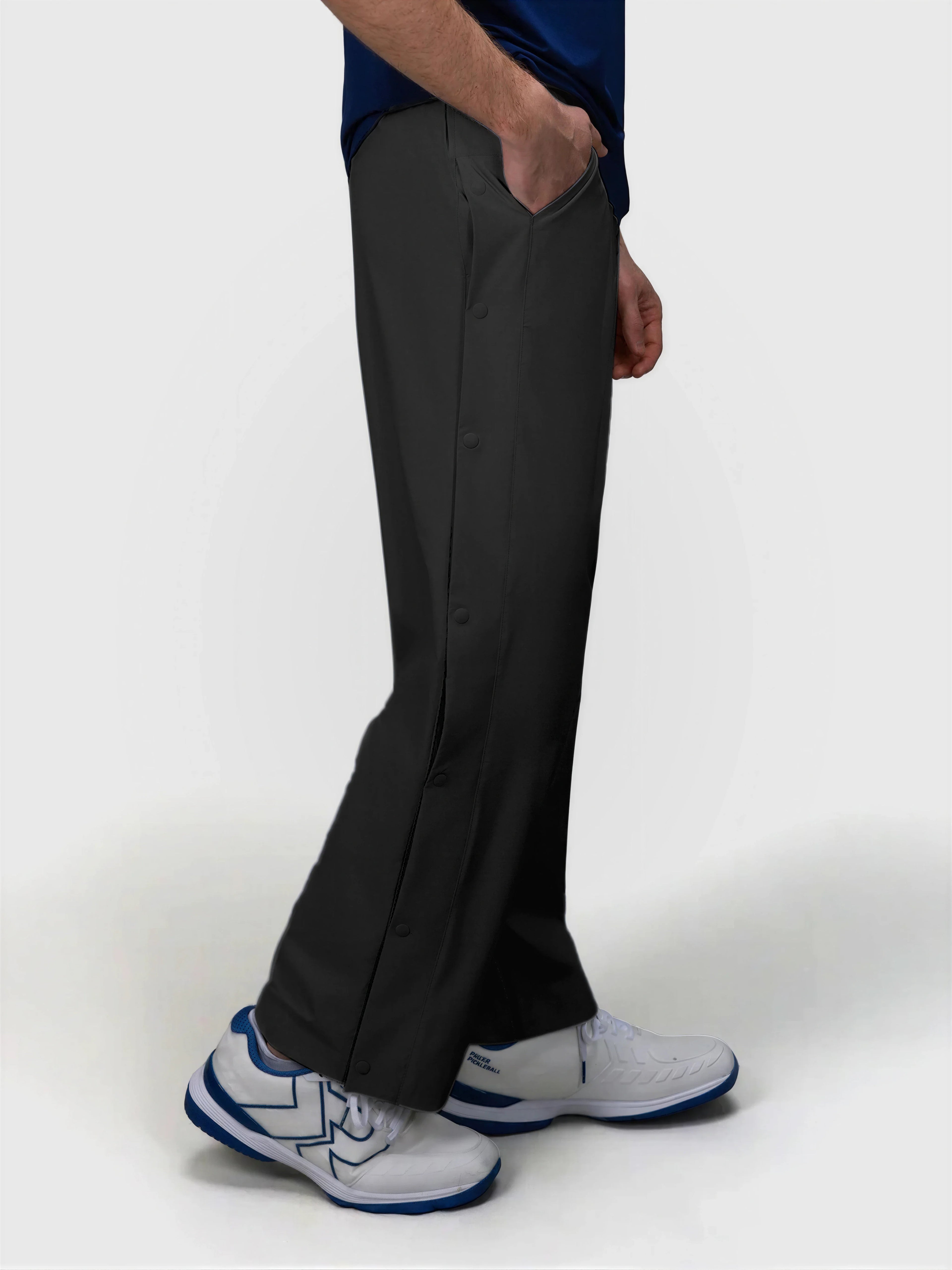 Side profile of black J Sas Tear Away Pant by MUEV designed for pickleball and padel apparel with snap button details