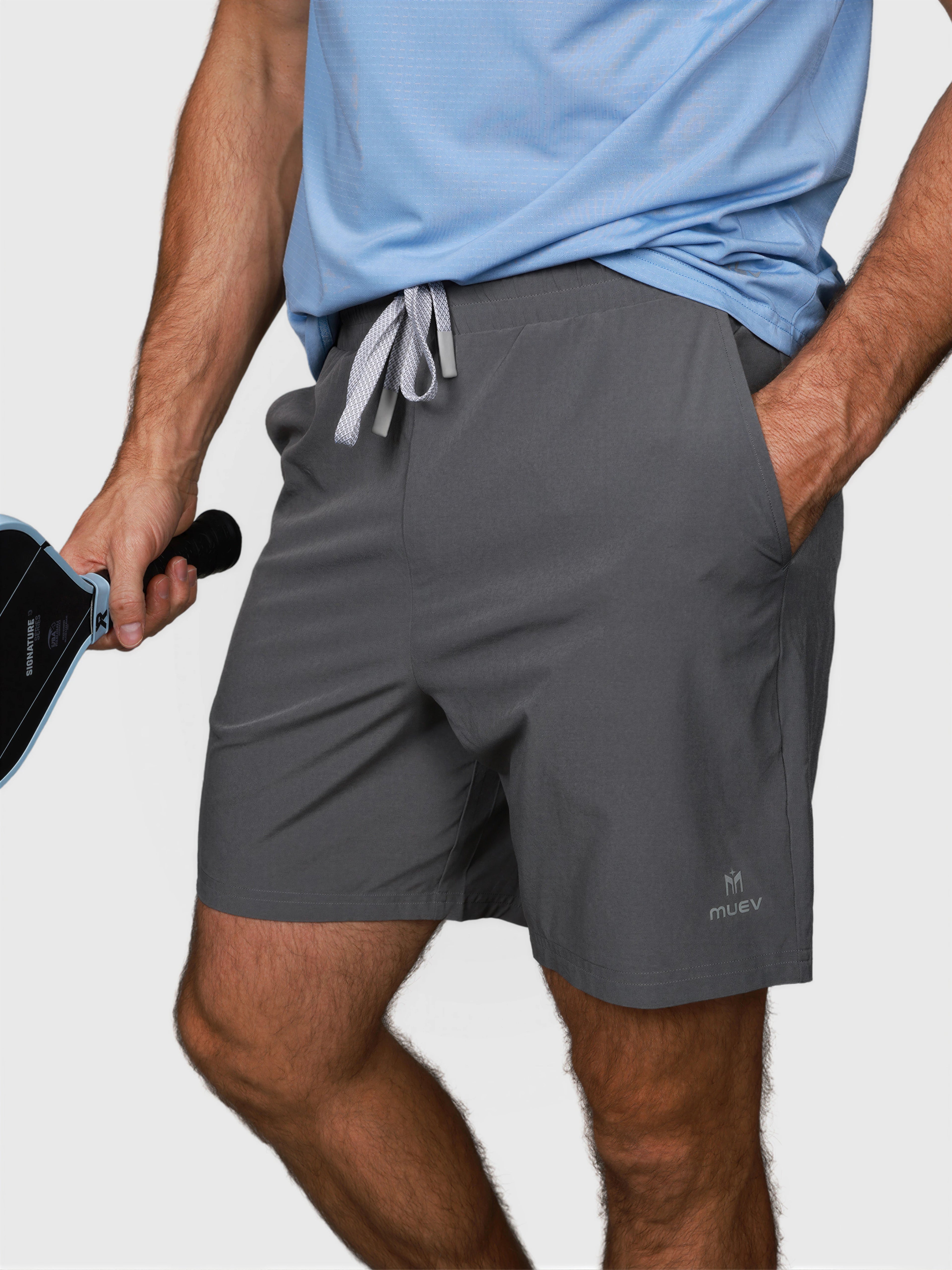 man wearing pewter gray Kick It Short by MUEV for padel and pickleball with drawstring waist and side pockets