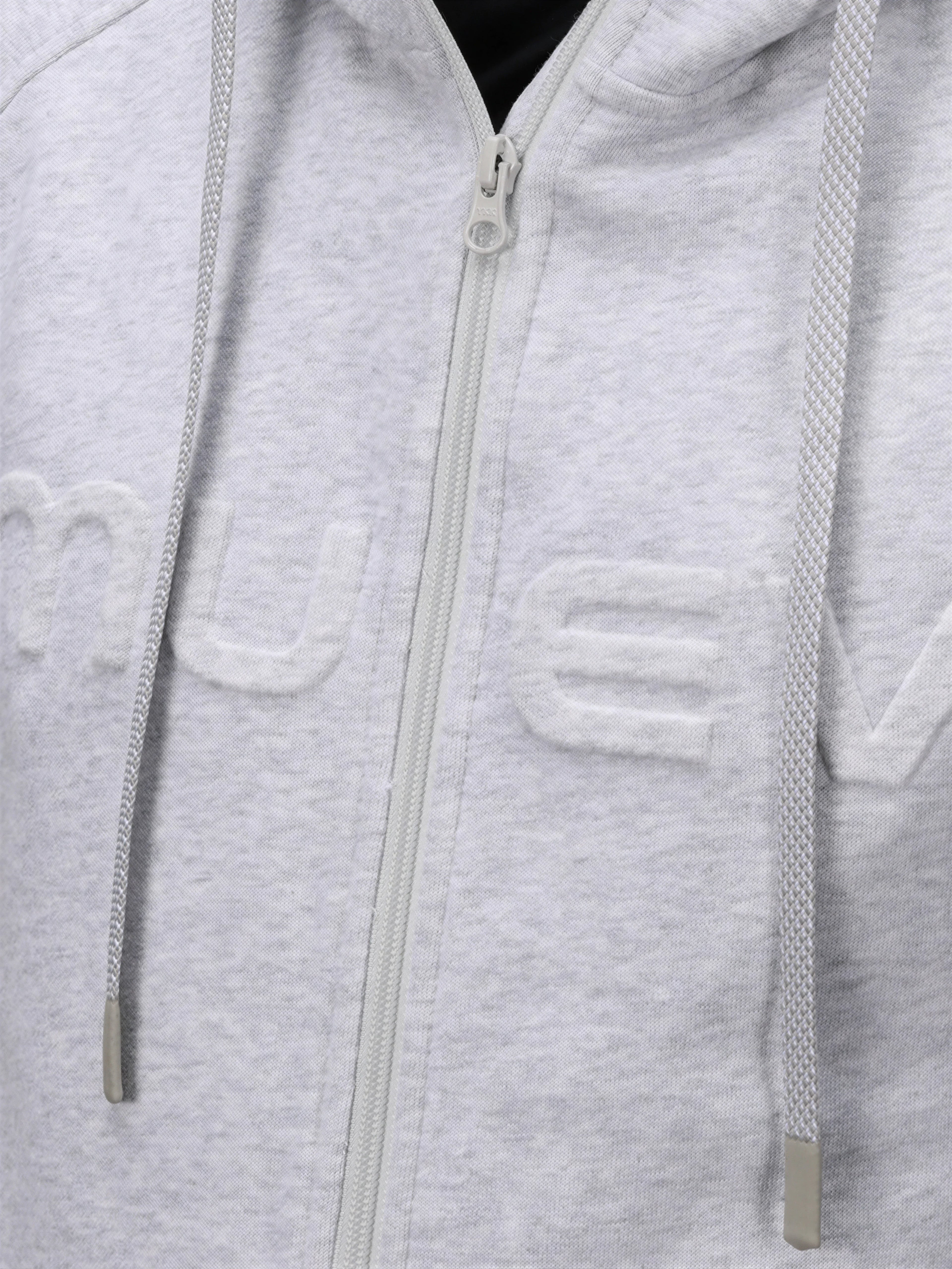 Close-up of Heather Gray Men's Off Court Full Zip Hoodie by MUEV with textured logo and drawstring details for padel apparel